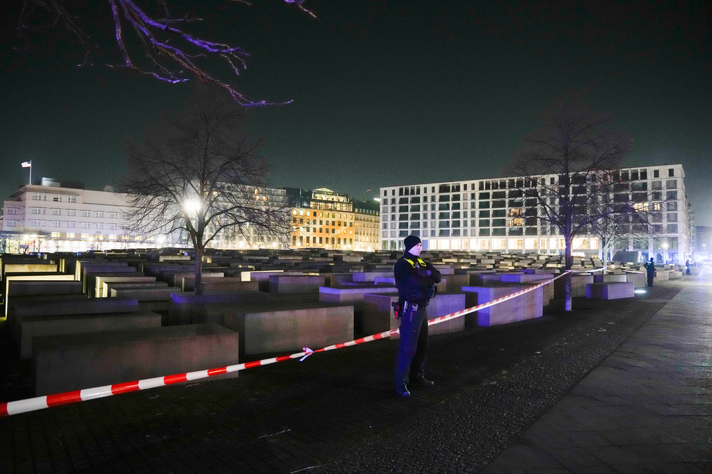 FILE - A police officer guards at the cordon at the Holocaust memorial after a man was attacked at the memorial site in Berlin, Germany, Friday, Feb. 21, 2025. (AP Photo/Ebrahim Noroozi, file)