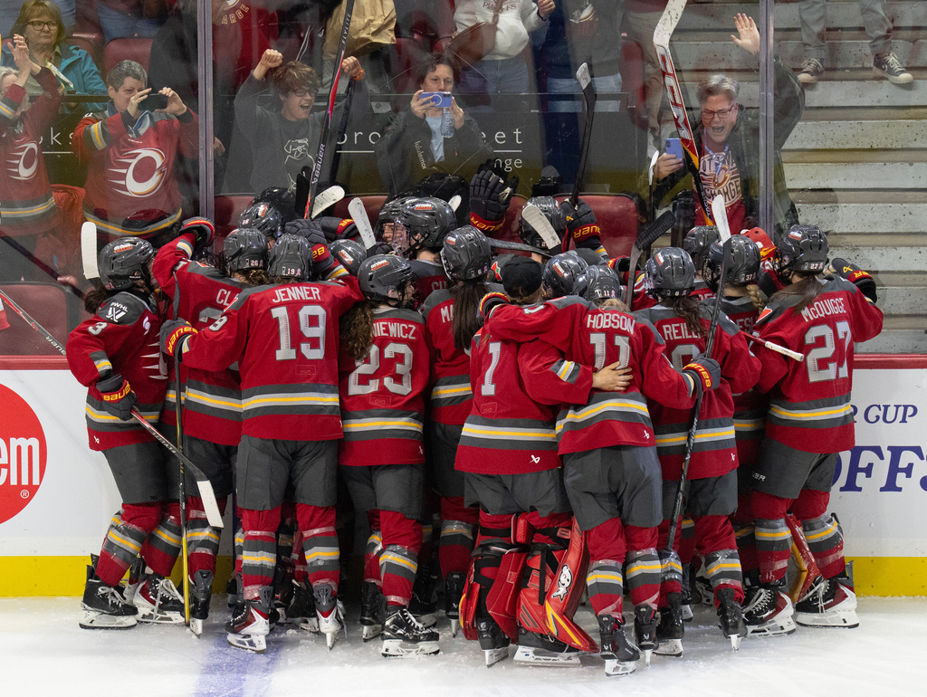 Ottawa Charge players celebrate after defeating the Boston Fleet in double overtime to win their PWHL hockey playoff series in Ottawa, Ontario, Sunday, May 10, 2026. (Adrian Wyld/The Canadian Press)