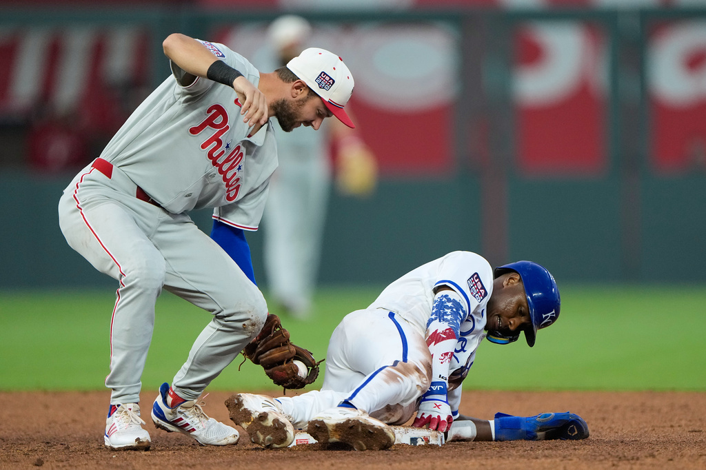 Kansas City Royals' Tyler Tolbert, right, beats the tag by Philadelphia Phillies shortstop Trea Turner to steal second during the fifth inning of a baseball game Saturday, July 4, 2026, in Kansas City, Mo. (AP Photo/Charlie Riedel)