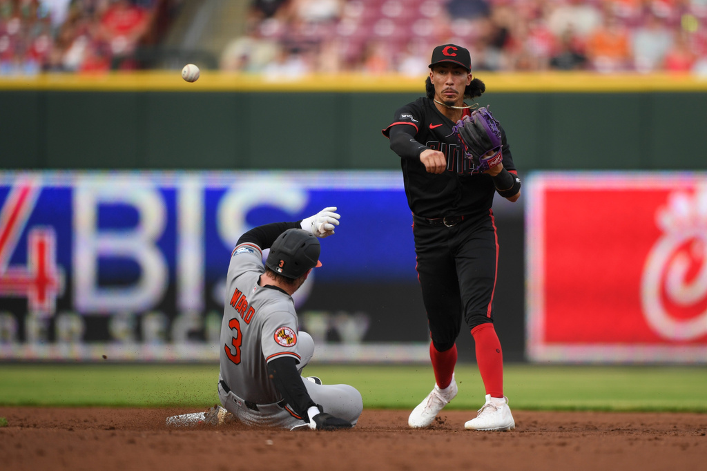 Cincinnati Reds second baseman Edwin Arroyo, right, turns a double play over Baltimore Orioles' Taylor Ward (3) during the third inning of a baseball game in Cincinnati, Friday, July 3, 2026. (AP Photo/Tanner Pearson)