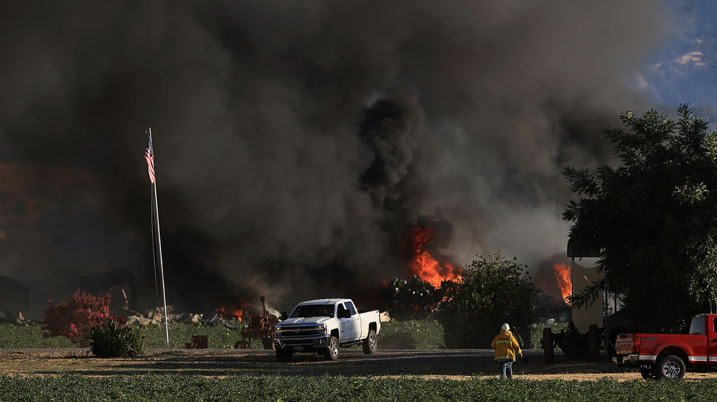 Smoke and flames rise during a fireworks warehouse explosion near Esparto, Calif., Tuesday, July 1, 2025. (Kent Porter/The Press Democrat via AP, File)