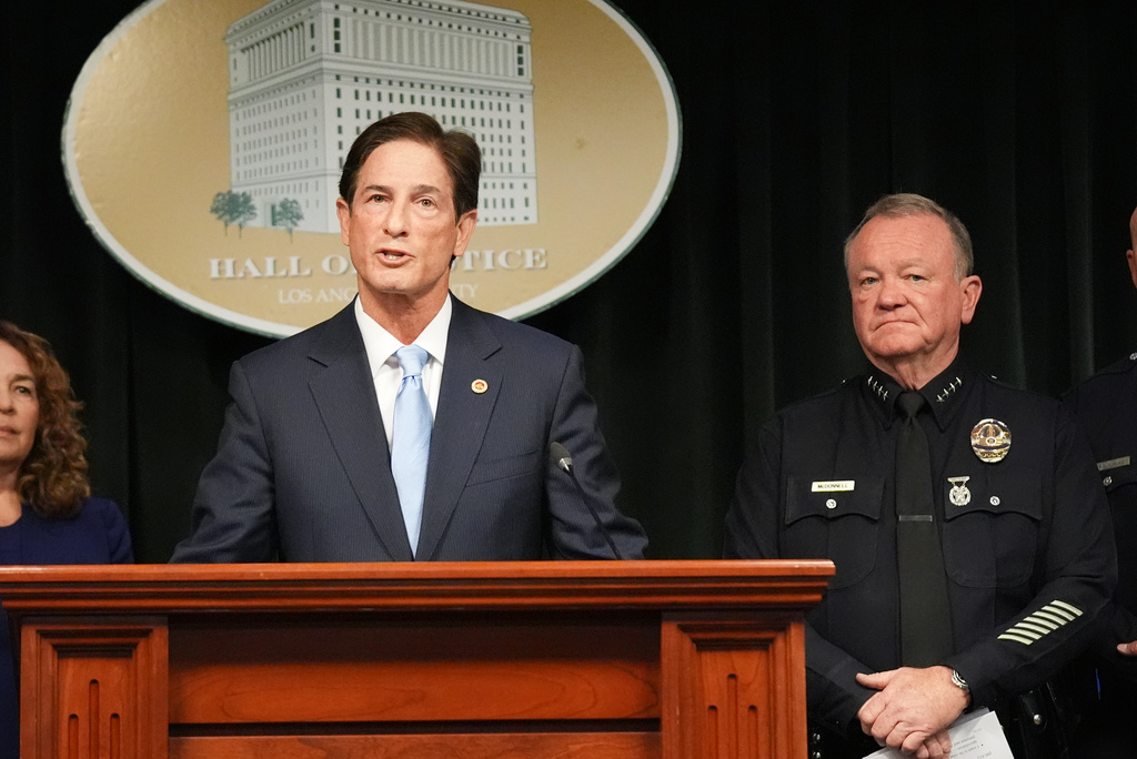 Los Angeles district attorney Nathan Hochman answers questions next to police chief Jim McDonnell Monday, April 20, 2026, in Los Angeles regarding the case of singer D4vd, who was charged on suspicion of killing a 14-year-old girl whose dismembered body was found in his car. (AP Photo/Damian Dovarganes)