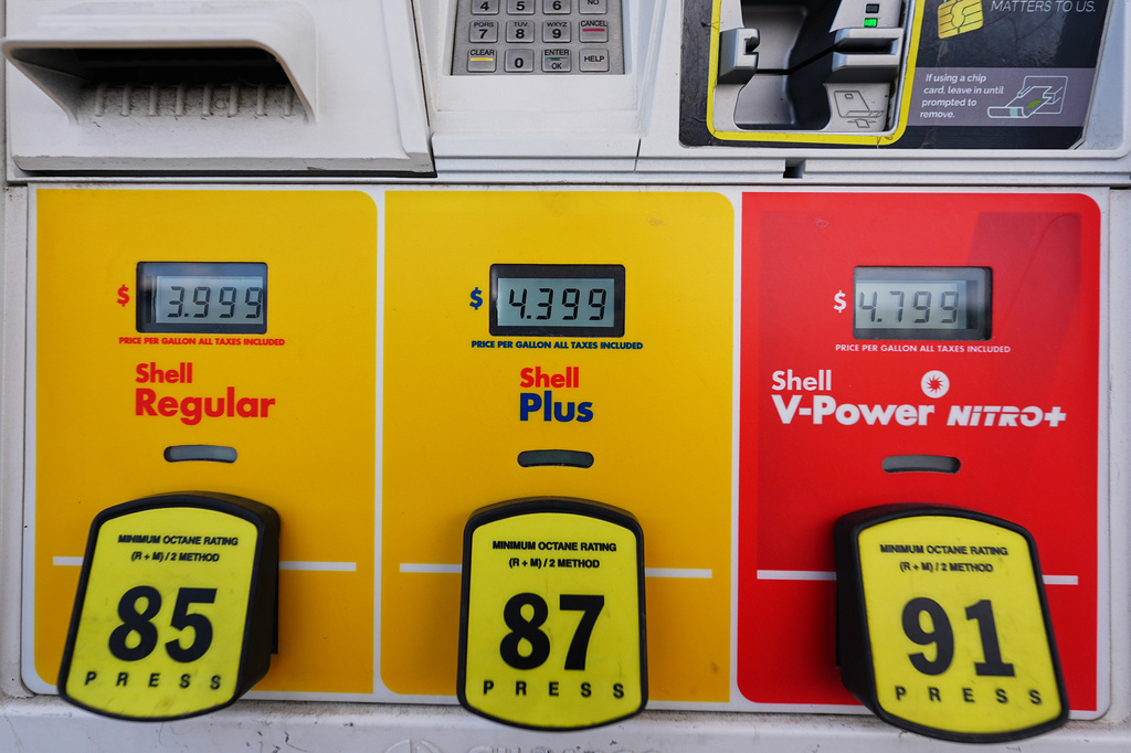 The per-gallon prices are illuminated electronically above the three grades of fuel available at a Shell gasoline station Monday, June 22, 2026, in Englewood, Colo. (AP Photo/David Zalubowski)