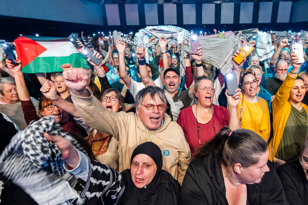 People wave flags and scarves during a United for Palestine anti-Eurovision concert in Brussels, Tuesday, May 12, 2026. (AP Photo/Geert Vanden Wijngaert)