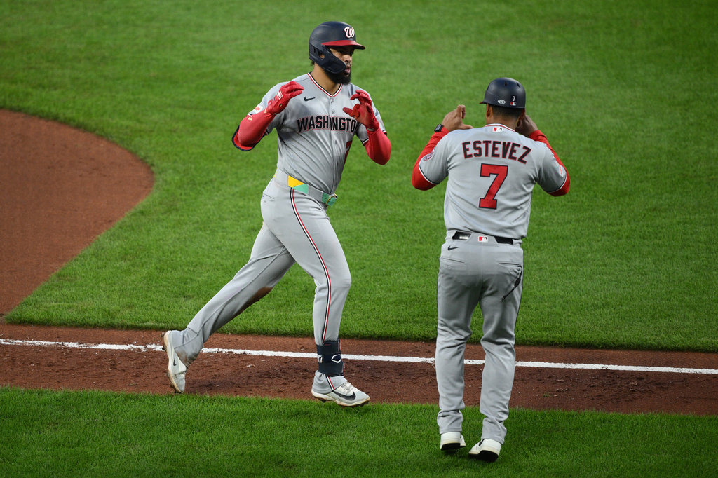 Washington Nationals' Luis Garcia Jr., left, celebrates with third base coach Victor Estevez (7) as he rounds the bases after hitting a home run during the fifth inning of a baseball game against the Baltimore Orioles, Saturday, June 27, 2026, in Baltimore. (AP Photo/Nick Wass)