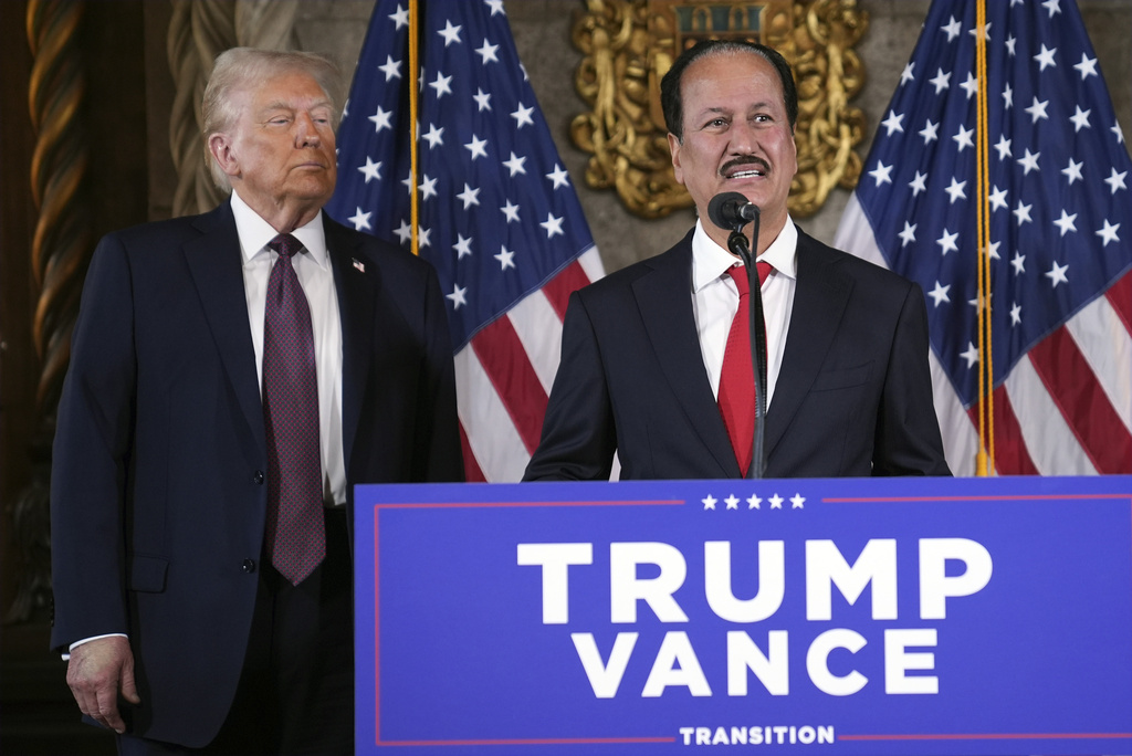 President-elect Donald Trump listens as Hussain Sajwani, CEO of DAMAC Properties, speaks during a news conference at Mar-a-Lago, Tuesday, Jan. 7, 2025, in Palm Beach, Fla. (AP Photo/Evan Vucci)