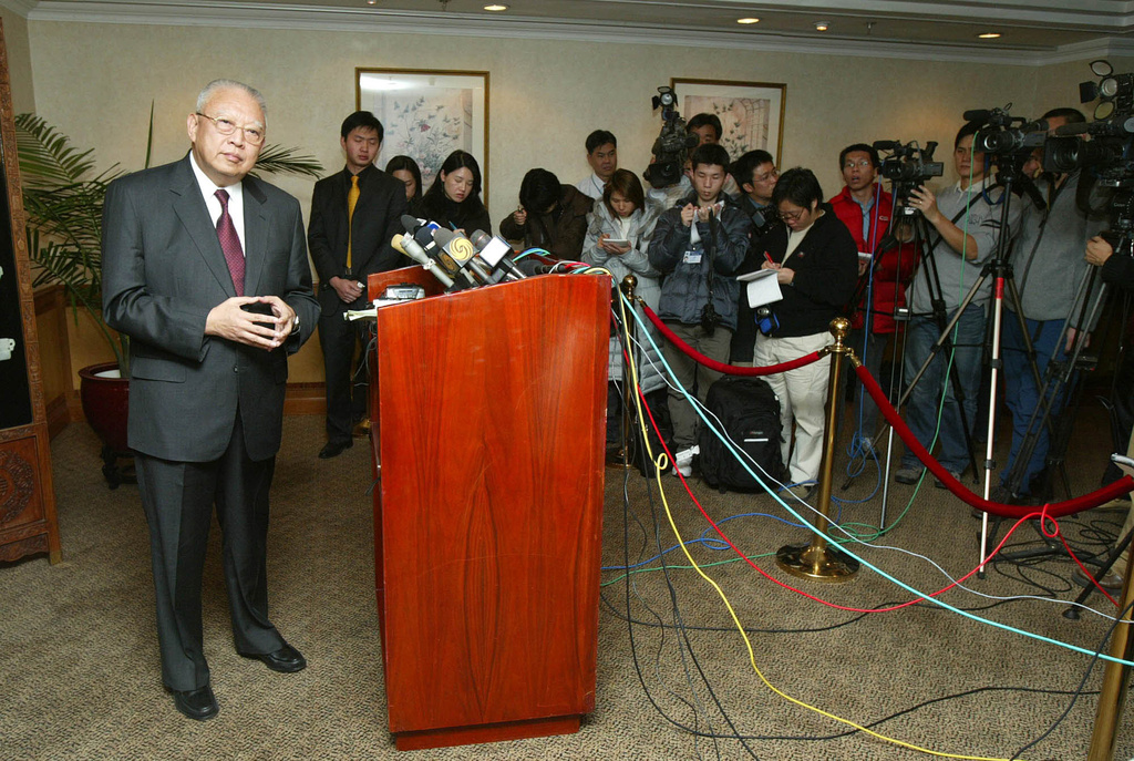 FILE - Hong Kong Chief Executive Tung Chee-hwa speaks to journalists after meetings with Chinese leaders in Beijing, Dec. 3, 2003. (AP Photo/Greg Baker, File)