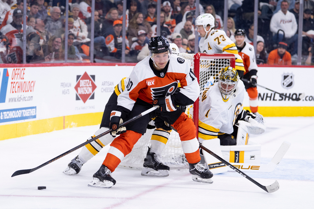 Philadelphia Flyers' Bobby Brink (10) tries to wrap the puck around Boston Bruins' goalie Jeremy Swayman (1) during the second period of an NHL hockey game Saturday, Feb. 28, 2026, in Philadelphia. (AP Photo/Chris Szagola)