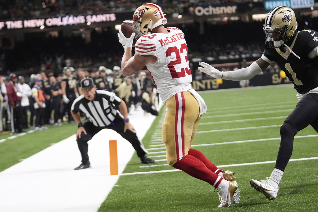 San Francisco 49ers running back Christian McCaffrey (23) catches a touchdown pass against the New Orleans Saints during the first half of an NFL football game in New Orleans, Sunday, Sept. 14, 2025. (AP Photo/Gerald Herbert)