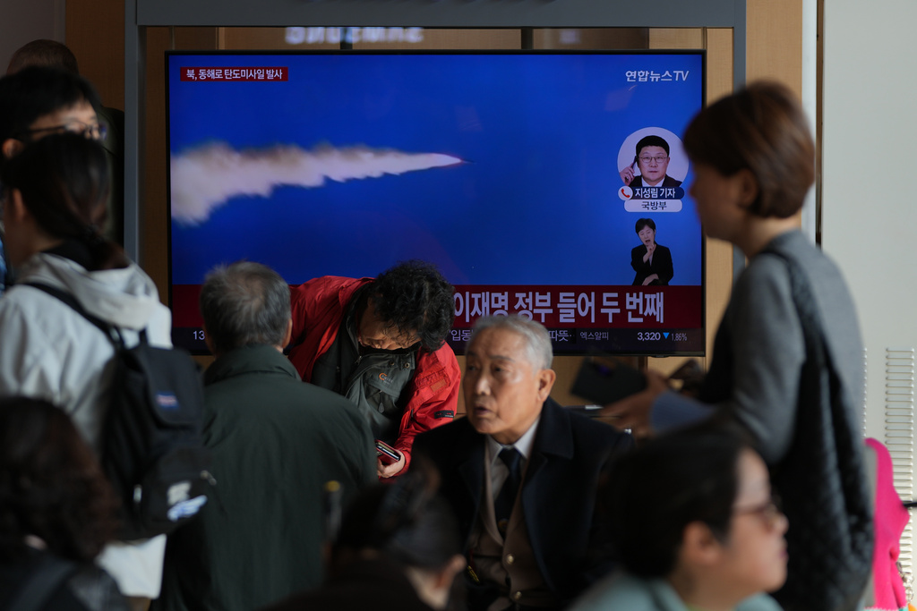 A TV screen shows a reporting of North Korea's ballistic missiles with file footage during a news program at the Seoul Railway Station in Seoul, South Korea, Friday, Nov. 7, 2025. (AP Photo/Lee Jin-man)
