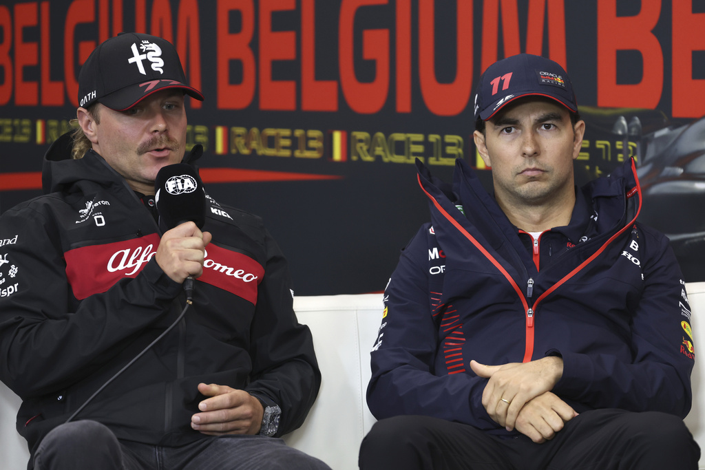 Alfa Romeo driver Valtteri Bottas of Finland, left, and Red Bull driver Sergio Perez of Mexico participate in a media conference ahead of the Formula One Grand Prix at the Spa-Francorchamps racetrack in Spa, Belgium, July 27, 2023. (AP Photo/Geert Vanden Wijngaert, file)