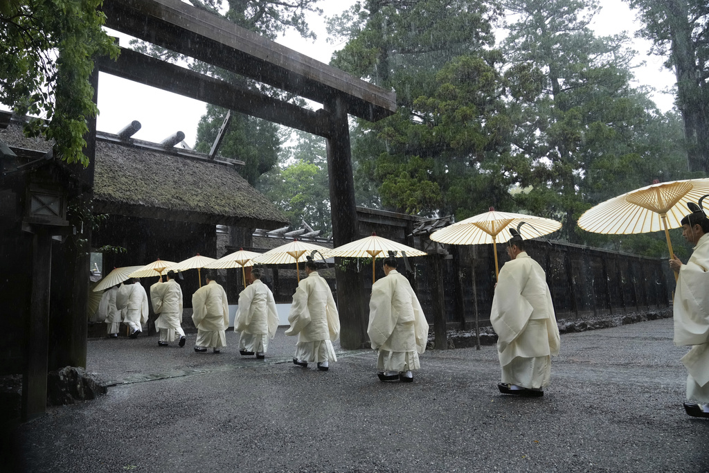 Shinto priests march into the main palace of Toyoukedaijingu, also known as Geku, or the outer sanctuary, of the Ise Jingu shrine complex as they begin Yamaguchisai, a kickoff ceremony of Shikinen Sengu, concluding in 2033, in Ise, central Japan, May 2, 2025. (AP Photo/Hiro Komae)