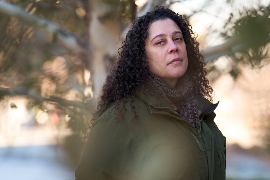Sidney Reid, 44, of Washington, poses for a portrait near where she was arrested while protesting immigration detentions, Tuesday, Dec. 16, 2025, in Washington. (AP Photo/Jacquelyn Martin)