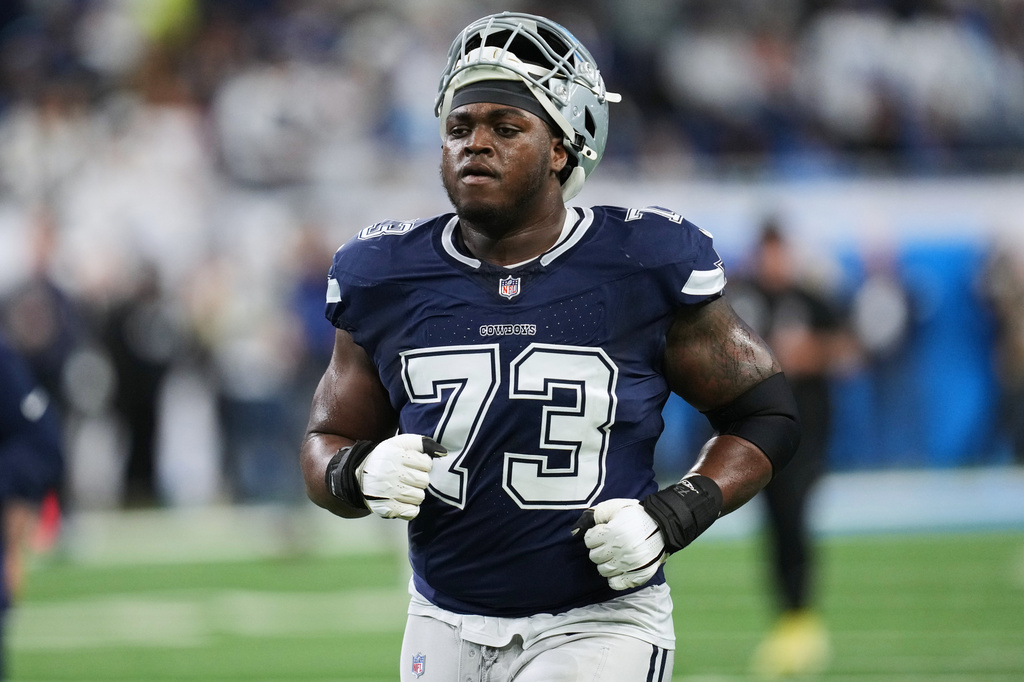 FILE - Dallas Cowboys offensive tackle Tyler Smith (73) warms up before an NFL football game against the Detroit Lions Thursday, Dec. 4, 2025, in Detroit. (AP Photo/Paul Sancya, File)