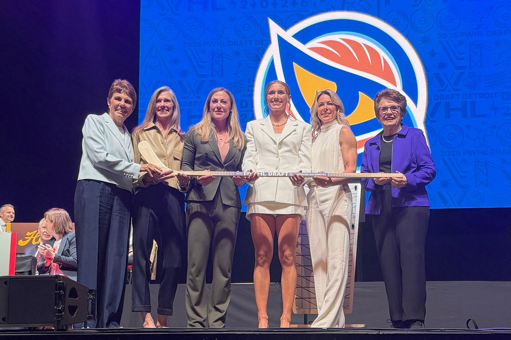 Wisconsin defender Caroline Harvey, center right, who was selected by the Vancouver Goldeneyes with the No. 1 overall pick in the PWHL draft, poses with Vancouver general manager Cara Gardner Morey, second from right, tennis icon and PWHL board member Billie Jean King, right, King's wife Ilana Kloss, left, Kimbra Walter, second left, and PWHL executive VP of hockey operations Jayna Hefford, center left, Wednesday, June 17, 2026, in Detroit. AP Photo/John Wawrow)