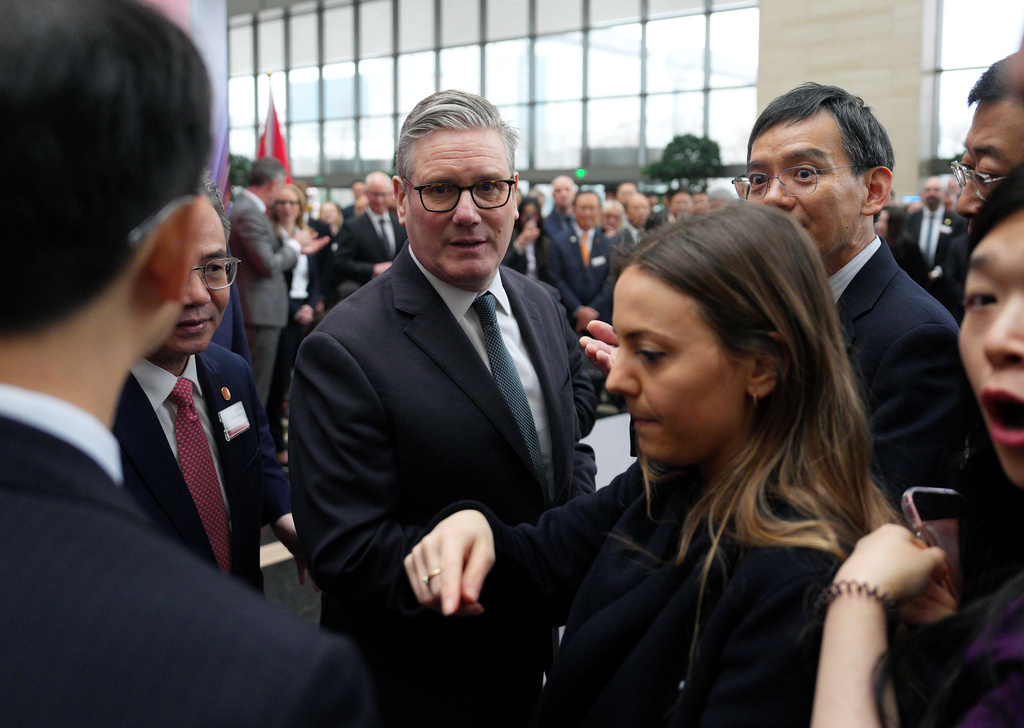 British Prime Minister Keir Starmer, center, arrives for a UK-China Business Forum at the Bank of China in Beijing Friday, Jan. 30, 2026. (Carl Court/Pool Photo via AP)