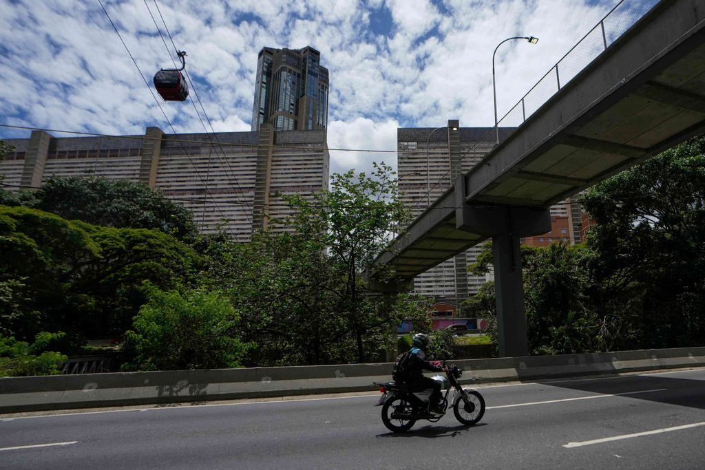 Motorcycle taxi driver David Rodriguez through Caracas, Venezuela, June 23, 2025. He traveled by land from Caracas to the U.S. border, crossing the Darien Gap, but was deported to Mexico by U.S. authorities and eventually gave up his hopes of reaching the United States, returning home. (AP Photo/Matias Delacroix)