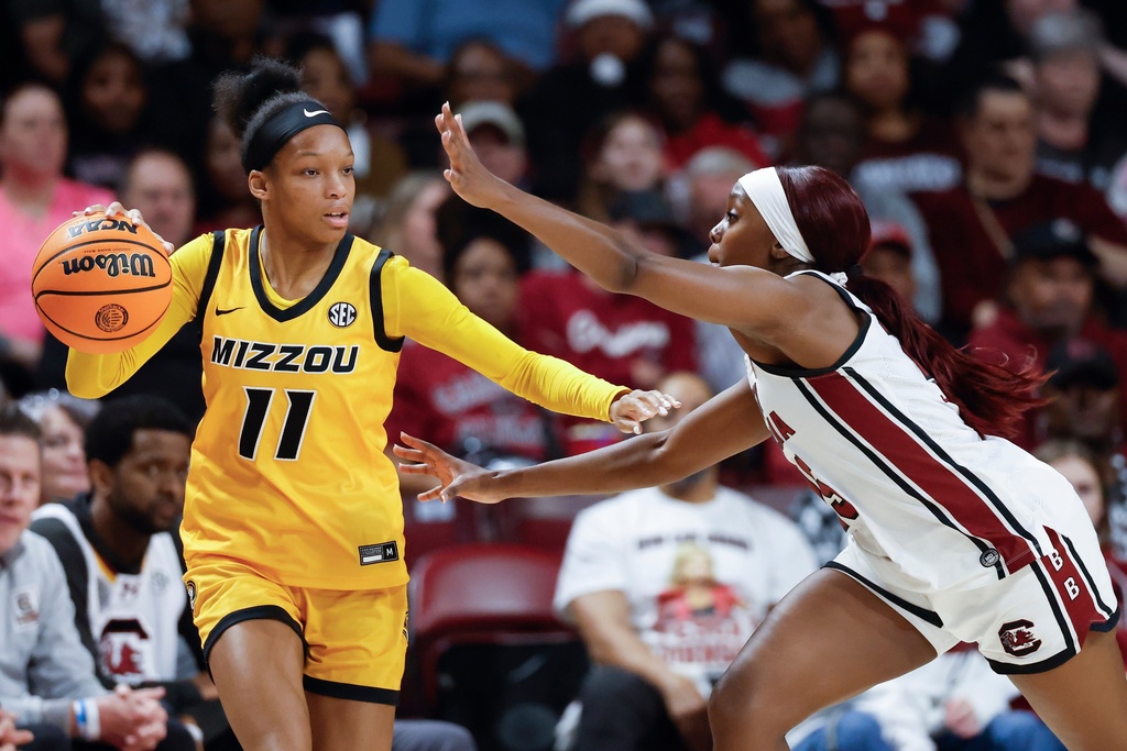 Missouri guard Jayla Smith (11) moves the ball against South Carolina guard Raven Johnson during the first half of an NCAA college basketball game in Columbia, S.C., Thursday, Feb. 26, 2026. (AP Photo/Nell Redmond)
