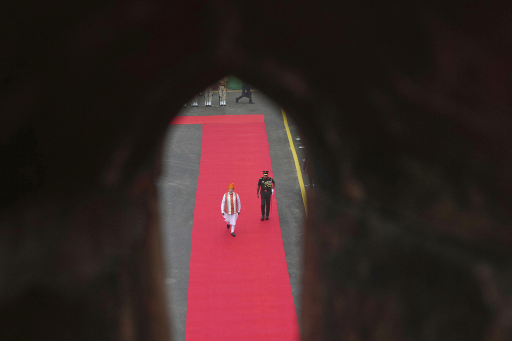 Indian Prime Minister Narendra Modi, left, arrives to address the nation from the rampart of the 17th century Mughal-era Red Fort monument during the country's Independence Day celebrations in New Delhi, India, Friday, Aug. 15, 2025. (AP Photo/Manish Swarup)