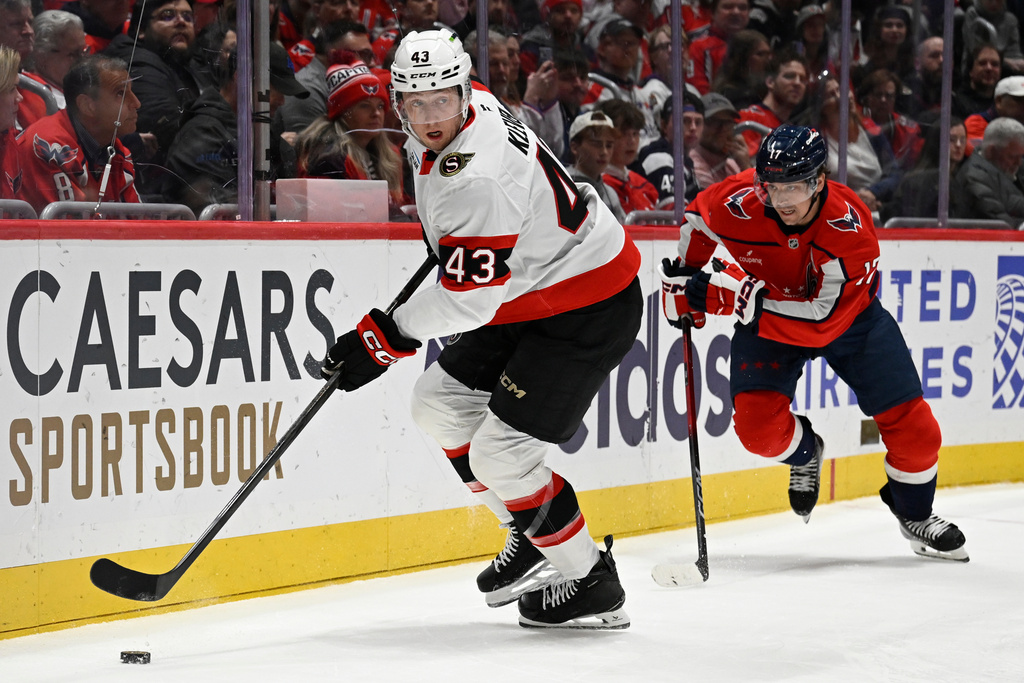 Ottawa Senators defenseman Tyler Kleven (43) gains control of the puck against Washington Capitals center Dylan Strome during the first period of an NHL hockey game, Wednesday, March 18, 2026, in Washington. (AP Photo/John McDonnell)