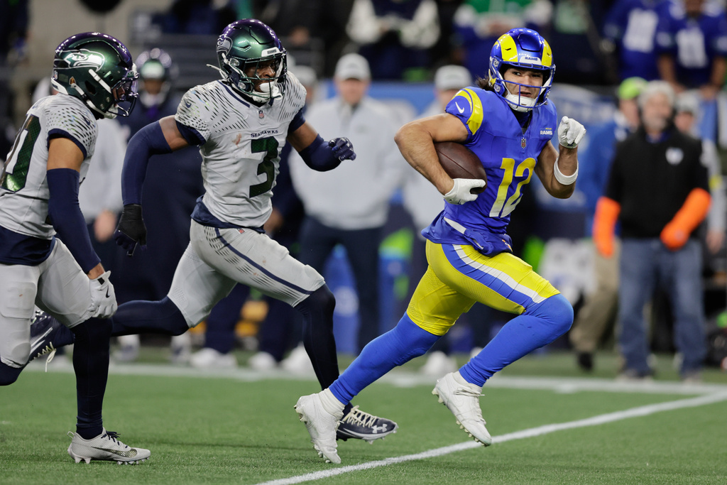 Los Angeles Rams wide receiver Puka Nacua (12) runs with the ball during the second half of an NFL football game against the Seattle Seahawks, Thursday, Dec. 18, 2025, in Seattle. (AP Photo/John Froschauer)