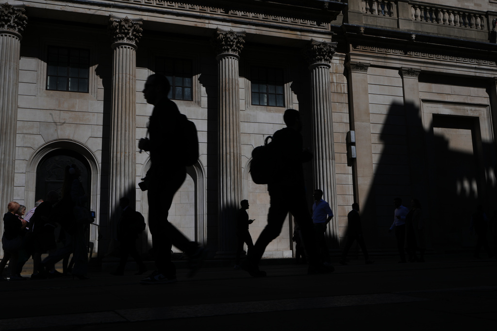 FILE -Pedestrians walk past the Bank of England in London, April 30, 2026. (AP Photo/Kirsty Wigglesworth, File)