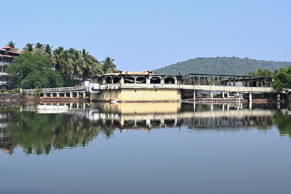 The nightclub, which caught fire on early Sunday, is seen across an expanse of water in Arpora, in Goa, India, Sunday, Dec. 7, 2025. (AP Photo)