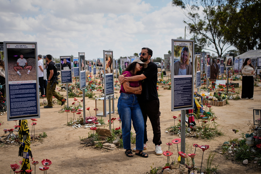 FILE - People mark Israel's annual Memorial Day at the site of the Nova music festival, where hundreds of revelers were killed and abducted in the Oct. 7, 2023 Hamas attack, near Kibbutz Reim in southern Israel, April 21, 2026. (AP Photo/Ohad Zwigenberg, File)