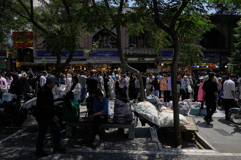 People walk around Tehran's traditional main bazaar, Iran, Thursday, July 16, 2026. (AP Photo/Vahid Salemi)
