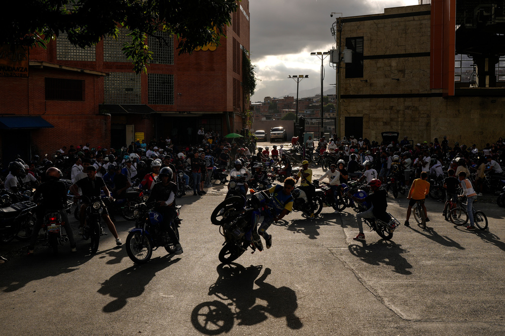 Motorcyclists perform stunts at a street event in the Petare neighborhood of Caracas, Venezuela, June 22, 2025. (AP Photo/Matias Delacroix)