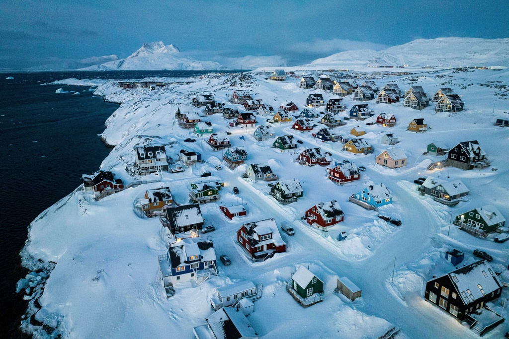 FILE - Houses covered in snow are seen on the coast of a sea inlet of Nuuk, Greenland, Friday, March 7, 2025. (AP Photo/Evgeniy Maloletka, File)