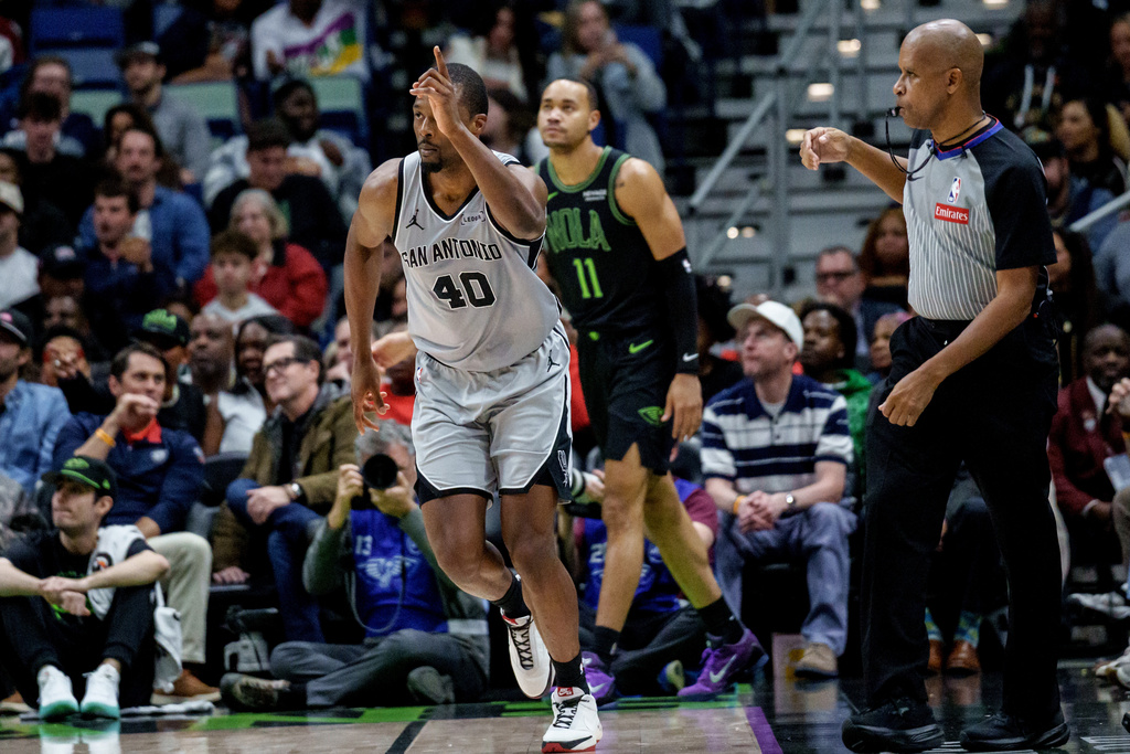 San Antonio Spurs forward Harrison Barnes (40) reacts after a three-point basket against New Orleans Pelicans guard Bryce McGowens (11) during the first half of an NBA basketball game in New Orleans, Monday, Dec. 8, 2025. (AP Photo/Matthew Hinton)