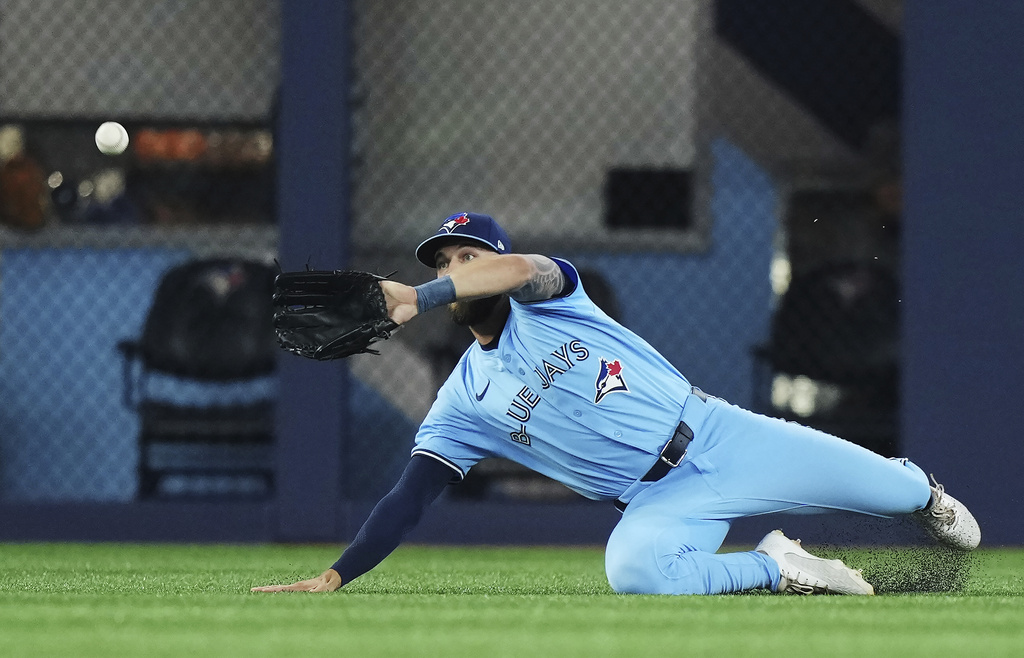 Toronto Blue Jays outfielder Nathan Lukes (38) makes a diving catch against the Chicago Cubs during second inning MLB baseball action in Toronto on Tuesday, August 12, 2025. (Nathan Denette/The Canadian Press via AP)