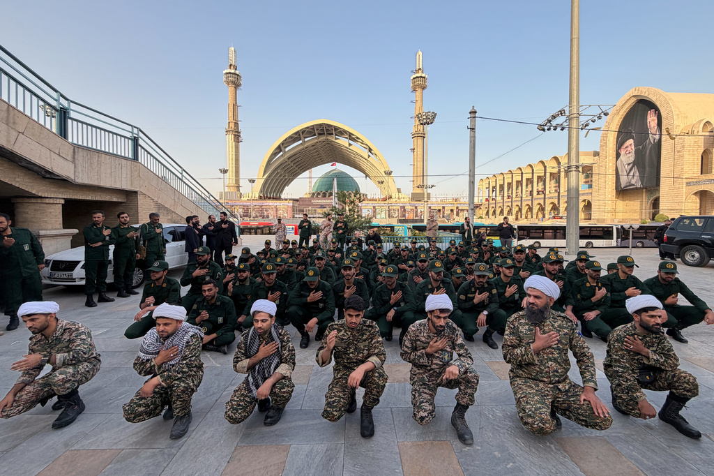 Revolutionary Guard members and clerics mourn on the esplanade of the Imam Khomeini Mosalla Grand Mosque as preparations are underway ahead of the dayslong funeral ceremonies for slain Iranian Supreme Leader Ayatollah Ali Khamenei in Tehran, Iran, Friday, July 3, 2026. (AP Photo/Vahid Salemi)