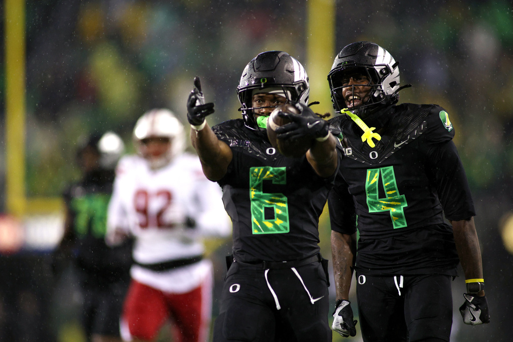 Oregon running back Noah Whittington (6) and Oregon wide receiver Malik Benson (4) celebrate after a run during the second half of an NCAA college football game against Wisconsin, Saturday, Oct. 25, 2025, in Eugene, Ore. (AP Photo/Lydia Ely)