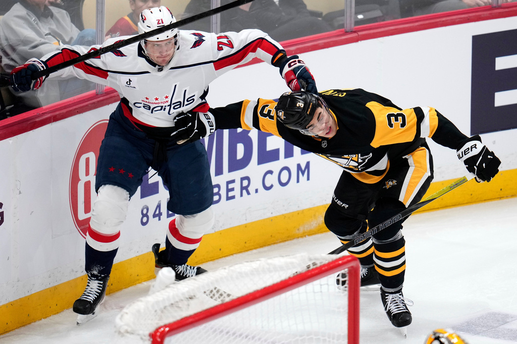 Washington Capitals' Aliaksei Protas (21) is defended by Pittsburgh Penguins' Jack St. Ivany during the first period of an NHL hockey game in Pittsburgh, Saturday, April 11, 2026. (AP Photo/Gene J. Puskar)