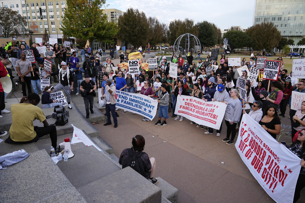 People protest against federal immigration enforcement Saturday, Nov. 15, 2025, in Charlotte, N.C. (AP Photo/Erik Verduzco)