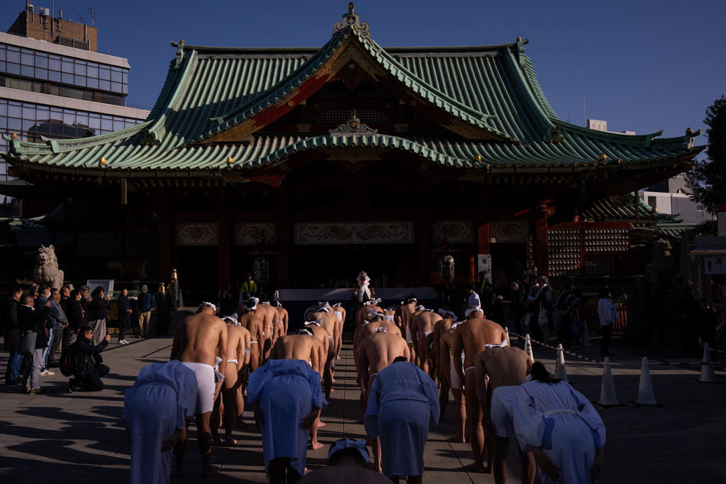 Participants prepare to bathe in ice-cold water to purify their souls and pray for good health during a New Year's ritual at Kanda Myojin Shrine in Tokyo, Saturday, Jan. 17, 2026. (AP Photo/Louise Delmotte)