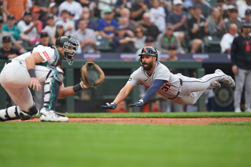 Detroit Tigers Riley Greene (31) dives to home and scores off a two run single from Colt Keith against the Seattle Mariners during the top of the third inning of a baseball game, Tuesday, Aug. 4, 2026, in Seattle. (AP Photo/Eric Hiller)