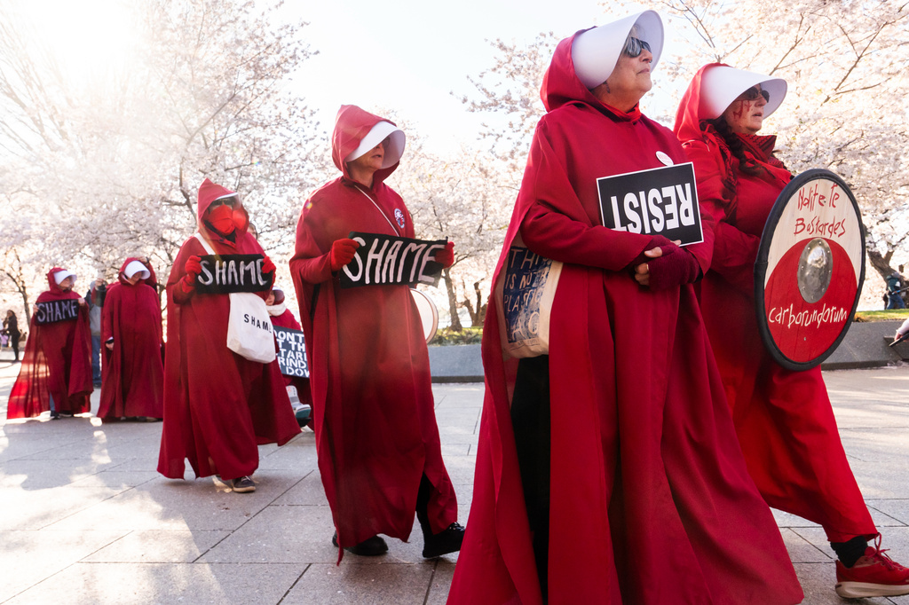 EDS NOTE: OBSCENITY - Demonstrators dressed as characters from the TV series, "The Handmaid's Tale," rally in front of the Martin Luther King, Jr. Memorial during the No Kings protest, Saturday, March 28, 2026, in Washington. (AP Photo/Julia Demaree Nikhinson)