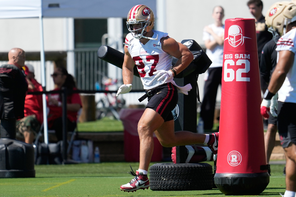 FILE - San Francisco 49ers defensive end Nick Bosa (97) runs a drill during the NFL football team's training camp, on July 27, 2026, in Santa Clara, Calif. (AP Photo/Jeff Chiu, File)