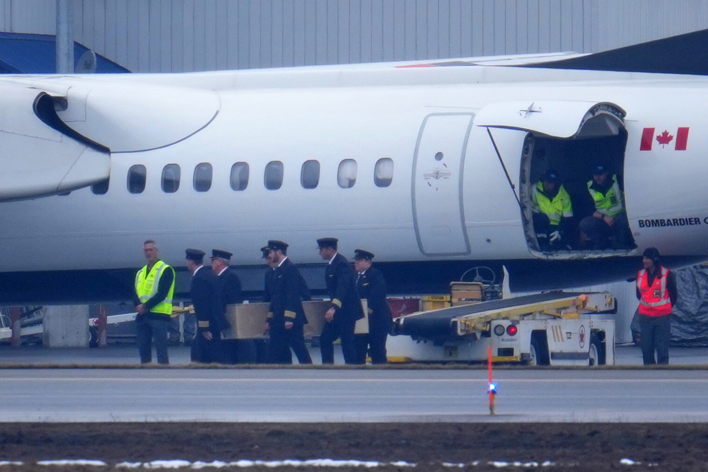 Pilots carry the casket during the repatriation of Jazz Aviation First Officer Mackenzie Gunther, in Ottawa, Ontario, Thursday, March 26, 2026. Gunther died Sunday after his Air Canada Express plane collided with a fire truck at New York's LaGuardia Airport. (Sean Kilpatrick/The Canadian Press via AP)