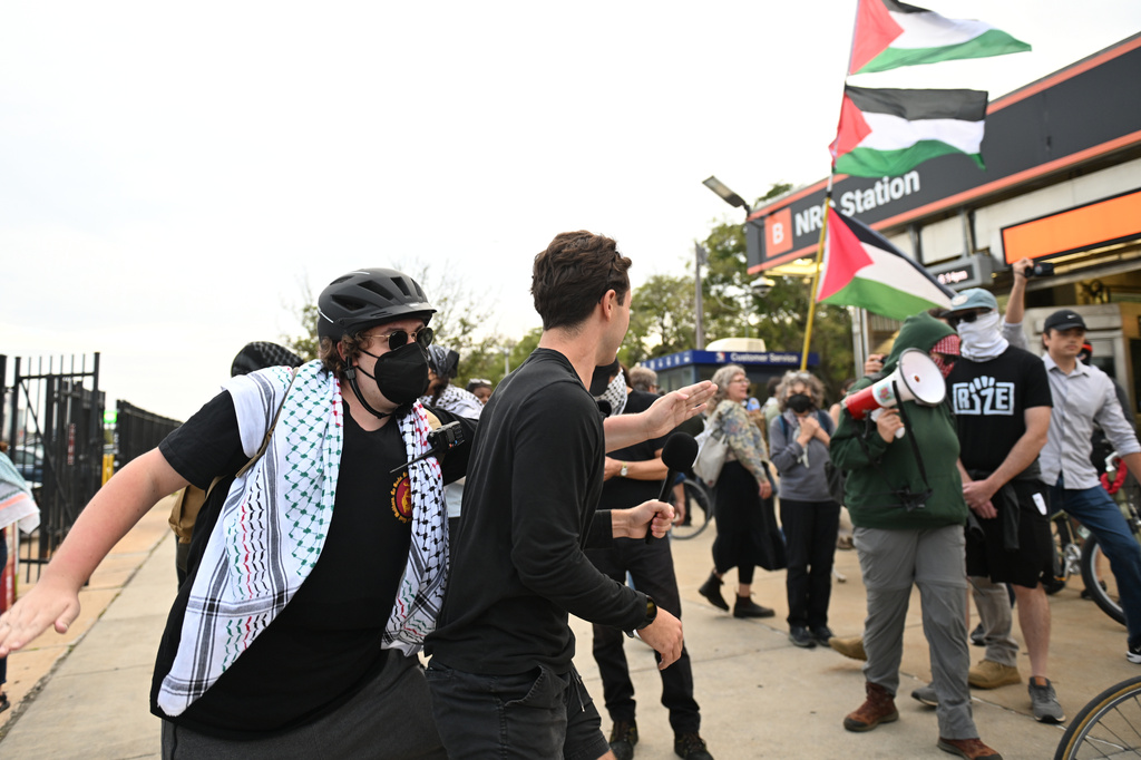 Pro Palestinian protesters, right, march past counter protesters during a protest before an Ed Sheeran concert in Philadelphia, Saturday, Sept. 19, 2026. (AP Photo/Allie Ippolito)