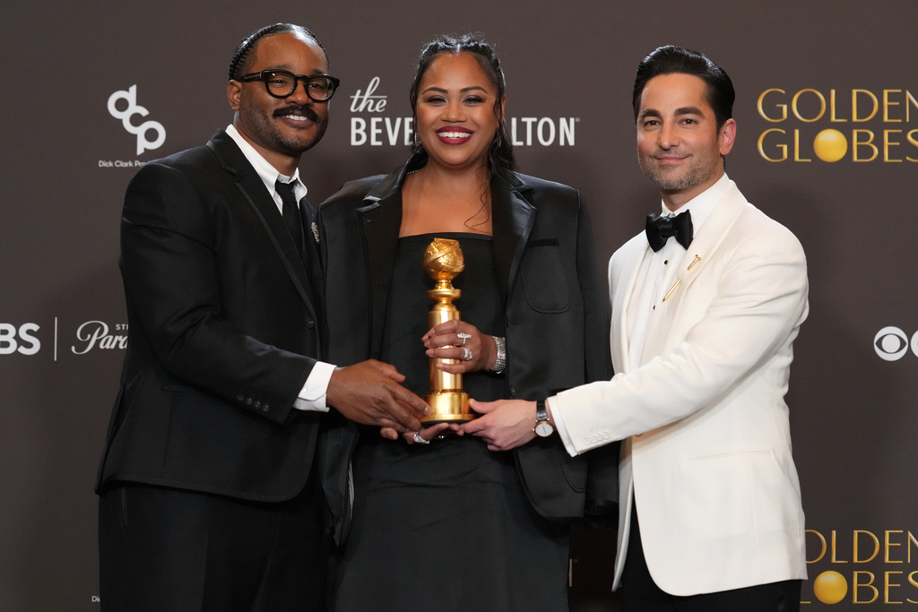 Ryan Coogler, from left, Zinzi Evans, and Sev Ohanian pose in the press room with the award for cinematic and box office achievement for "Sinners" during the 83rd Golden Globes on Sunday, Jan. 11, 2026, at the Beverly Hilton in Beverly Hills, Calif. (AP Photo/Chris Pizzello)