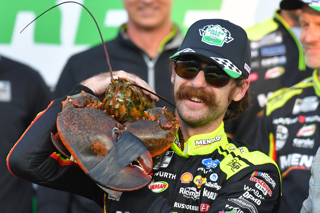 Ryan Blaney displays a lobster, a Victory Lane tradition at New Hampshire Motor Speedway, after winning a NASCAR Cup Series auto race, Sunday, Aug. 23, 2026, at the speedway in Loudon, N.H. (AP Photo/Steven Senne)