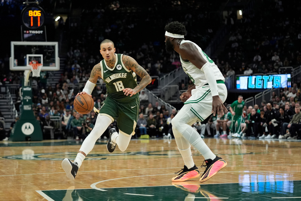 Milwaukee Bucks' Kyle Kuzma (18) drives to the basket against Boston Celtics' Neemias Queta during the first half of an NBA basketball game Thursday, Dec. 11, 2025, in Milwaukee. (AP Photo/Aaron Gash)