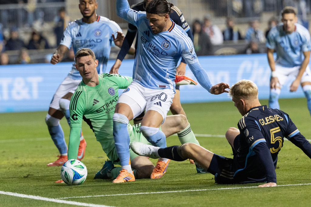 New York City FC goalkeeper Matt Freese, center left, stops a shot on goal by Philadelphia Union defender Jakob Glesnes (5) during the first half of MLS soccer's Eastern Conference semifinal, Sunday, Nov. 23, 2025, in Chester, Pa. (AP Photo/Laurence Kesterson)