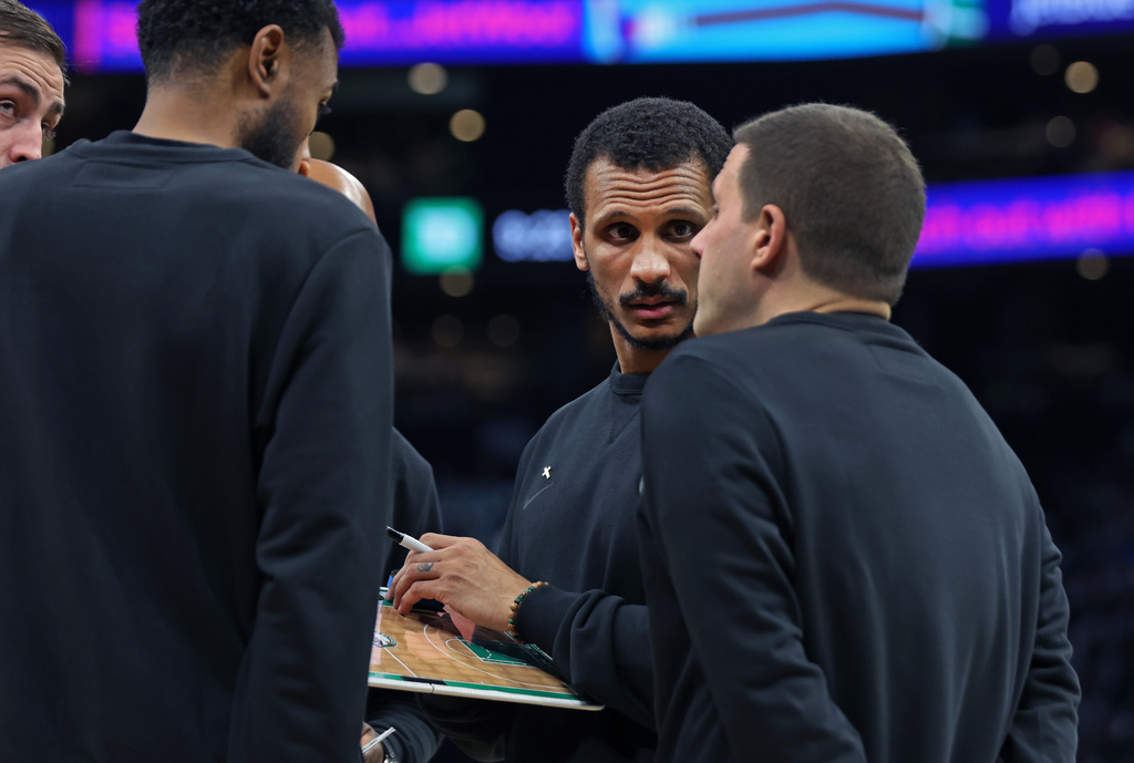 Boston Celtics' head coach Joe Mazzulla, center, is pictured with some of his assistant coaches during a timeout in the fourth quarter of Game 7 of a first round NBA basketball playoffs series against the Philadelphia 76ers, Saturday, May 2, 2026 in Boston. (AP Photo/Jim Davis)