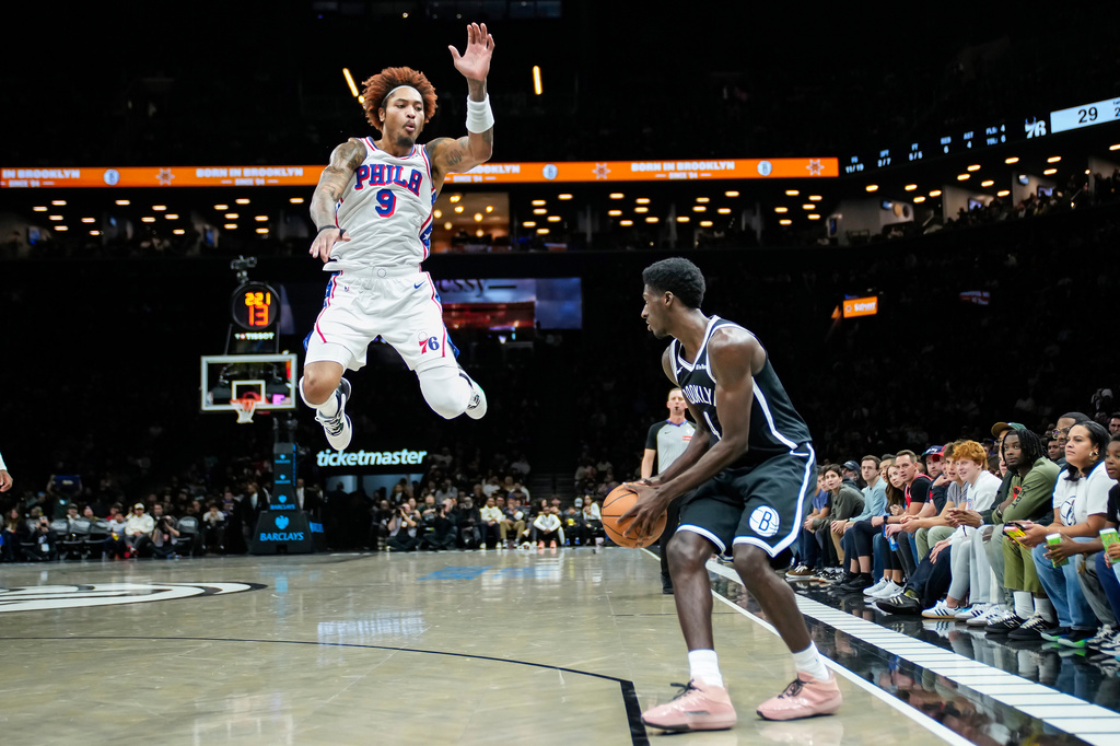 Philadelphia 76ers' Kelly Oubre Jr. (9) jumps to block a shot by Brooklyn Nets' Drake Powell, right, during the first half of an NBA basketball game Sunday, Nov. 2, 2025, in New York. (AP Photo/Eduardo Munoz Alvarez)