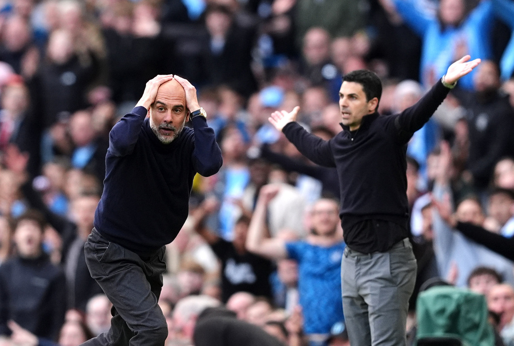 Manchester City's head coach Pep Guardiola and Arsenal manager Mikel Arteta react during the English Premier League soccer match between Manchester City and and Arsenal, in Manchester, England, Sunday, April 19, 2026. (Martin Rickett/PA via AP)